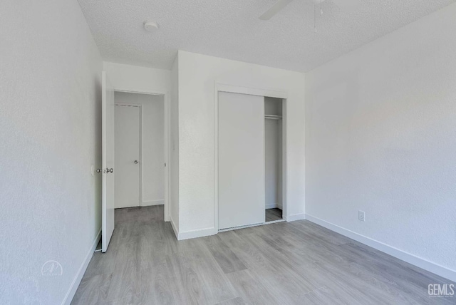 1857 Fern Tree Close, Wasco, CA 93280 - unfurnished bedroom featuring light wood-style floors, a textured ceiling, a closet, and a ceiling fan
