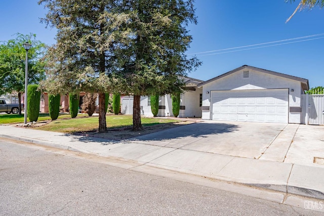 1857 Fern Tree Close, Wasco, CA 93280 - ranch-style house with stucco siding, driveway, an attached garage, and a front yard