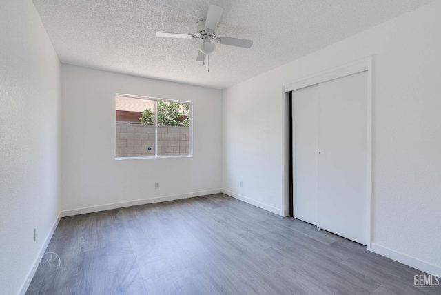 1857 Fern Tree Close, Wasco, CA 93280 - unfurnished bedroom featuring wood finished floors, a textured ceiling, ceiling fan, and a closet