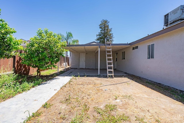 1857 Fern Tree Close, Wasco, CA 93280 - rear view of property with stucco siding, an attached carport, and concrete driveway