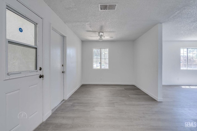 1857 Fern Tree Close, Wasco, CA 93280 - entrance foyer featuring a ceiling fan, a textured ceiling, and wood finished floors