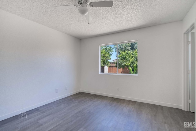 1857 Fern Tree Close, Wasco, CA 93280 - spare room with dark wood-style floors, ceiling fan, and a textured ceiling