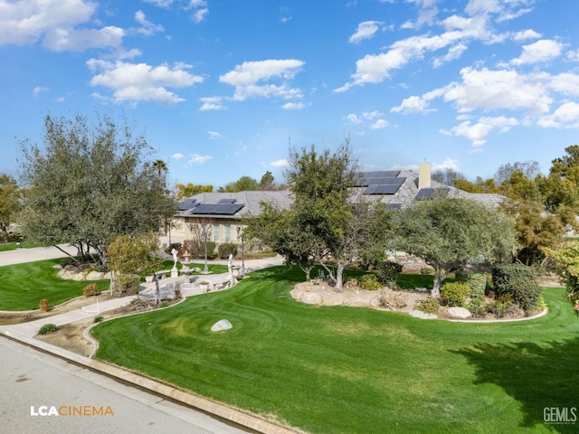 view of home's community with a yard and golf course view