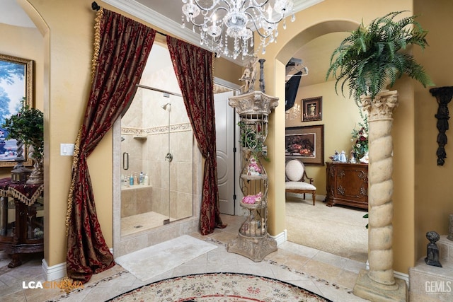 bathroom featuring ornate columns, a stall shower, tile patterned flooring, and a notable chandelier