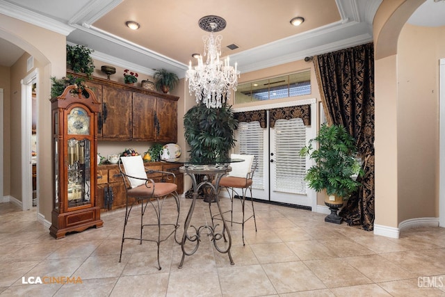 dining area featuring arched walkways, light tile patterned floors, crown molding, and an inviting chandelier