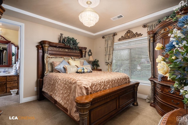 bedroom featuring light colored carpet, visible vents, a notable chandelier, and a tray ceiling