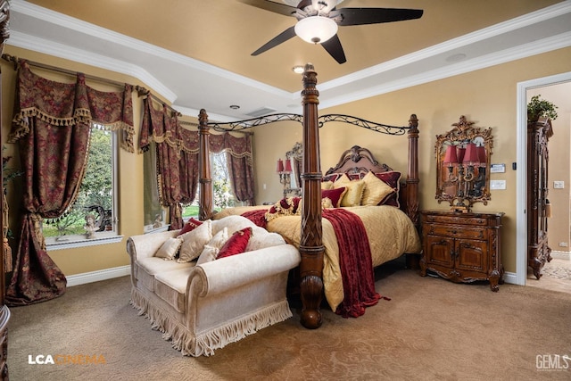 carpeted bedroom featuring baseboards, a tray ceiling, and ornamental molding