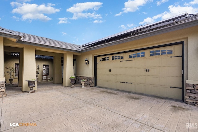 garage with decorative driveway