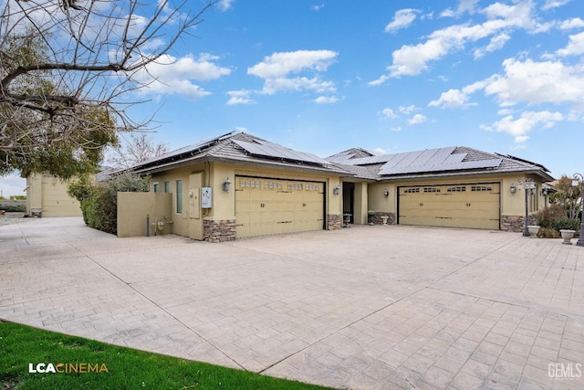 ranch-style home with a garage, stone siding, and stucco siding