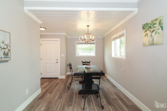 dining room featuring wood-type flooring, crown molding, and a chandelier