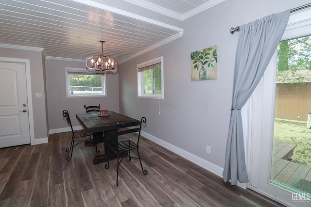 dining space with dark wood-type flooring, ornamental molding, and a notable chandelier