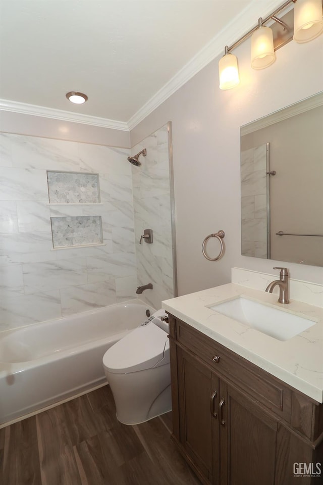 full bathroom featuring vanity, crown molding, hardwood / wood-style flooring, toilet, and tiled shower / bath