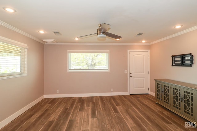 unfurnished room with ceiling fan, a healthy amount of sunlight, dark hardwood / wood-style floors, and ornamental molding