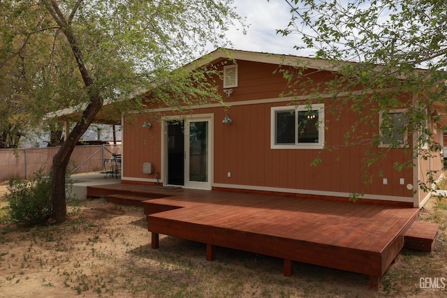 rear view of property with a wooden deck