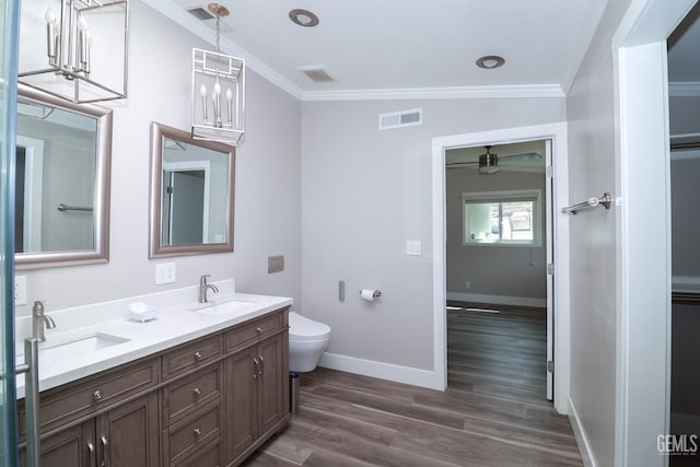 bathroom with crown molding, wood-type flooring, lofted ceiling, toilet, and vanity