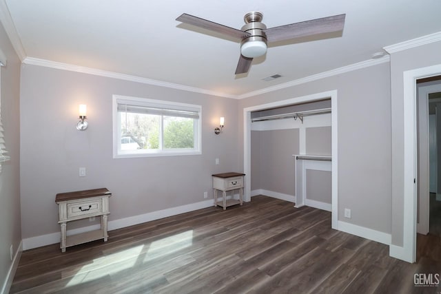 unfurnished bedroom featuring dark hardwood / wood-style flooring, a closet, ceiling fan, and ornamental molding