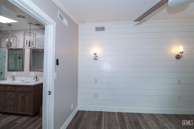 interior space featuring hardwood / wood-style flooring, vanity, and ornamental molding