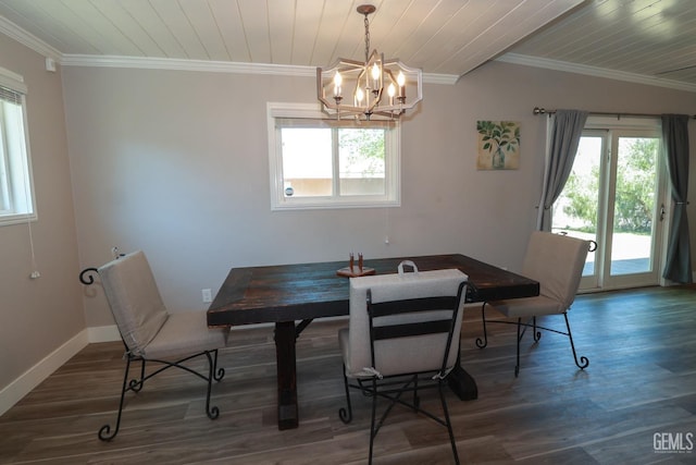 dining space featuring dark hardwood / wood-style floors, ornamental molding, and a chandelier