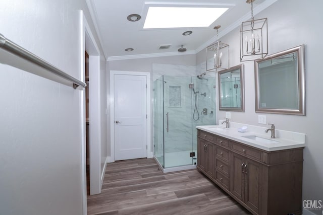 bathroom with ornamental molding, lofted ceiling, a shower with door, vanity, and hardwood / wood-style flooring