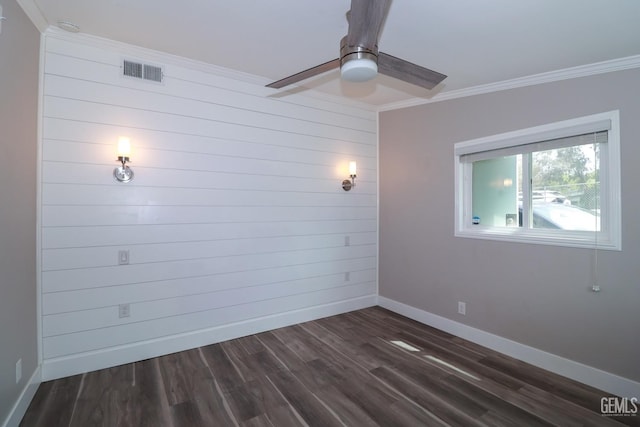 spare room featuring ceiling fan, crown molding, and dark wood-type flooring