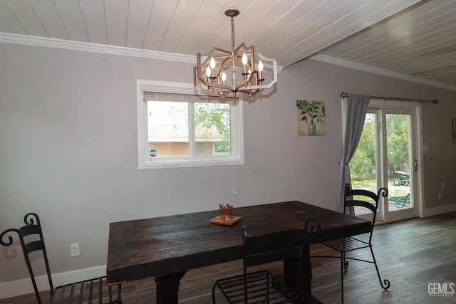 dining space featuring hardwood / wood-style flooring, crown molding, and a notable chandelier