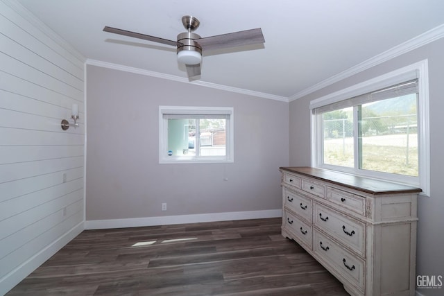 unfurnished bedroom featuring dark hardwood / wood-style flooring, vaulted ceiling, ceiling fan, and crown molding