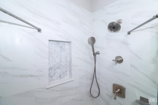 bathroom with a tile shower