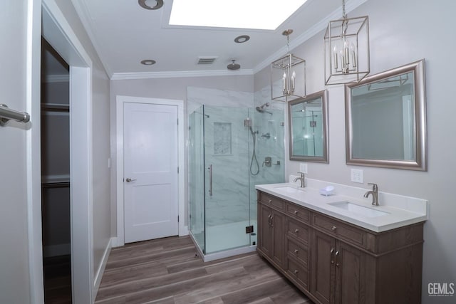 bathroom with vanity, lofted ceiling, ornamental molding, walk in shower, and wood-type flooring