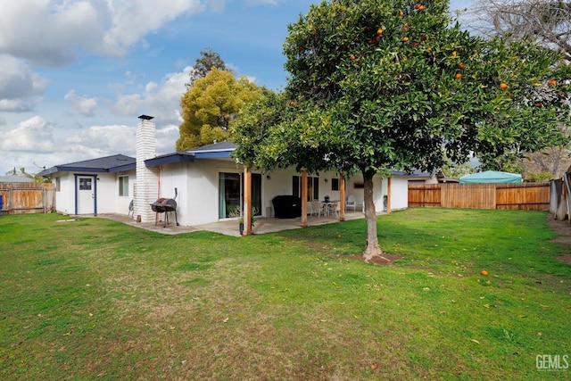 back of property featuring a patio and a lawn