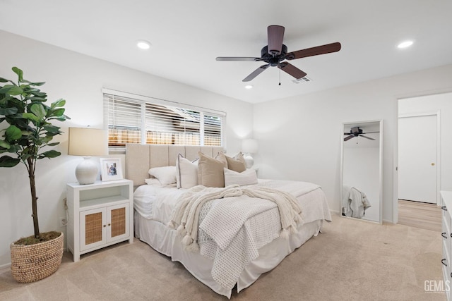 bedroom with ceiling fan and light carpet