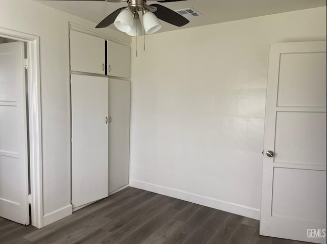 115 Olive St, Bakersfield, CA 93304 - unfurnished bedroom featuring dark wood-style floors, baseboards, and visible vents