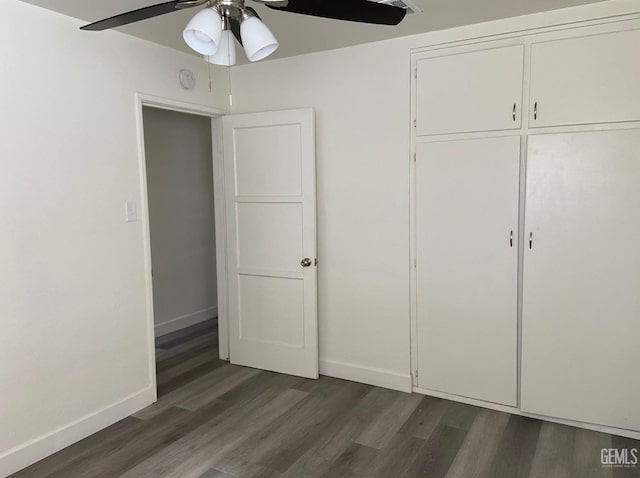 115 Olive St, Bakersfield, CA 93304 - unfurnished bedroom featuring a closet, baseboards, a ceiling fan, and wood finished floors