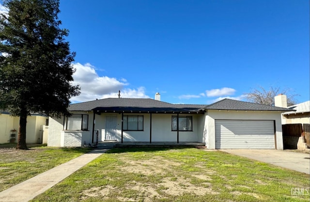 115 Olive St, Bakersfield, CA 93304 - single story home with a garage, stucco siding, fence, a front lawn, and concrete driveway