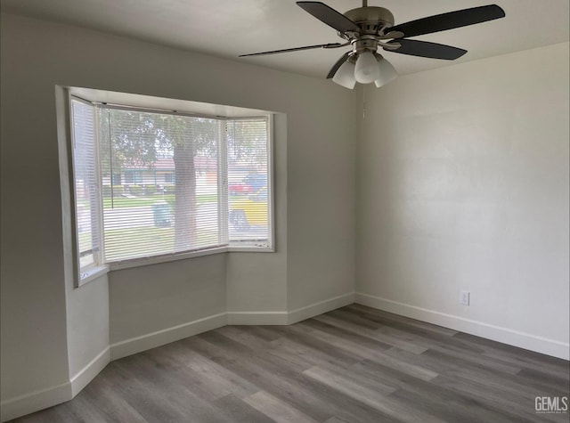 115 Olive St, Bakersfield, CA 93304 - unfurnished room featuring wood finished floors, ceiling fan, baseboards, and a wealth of natural light