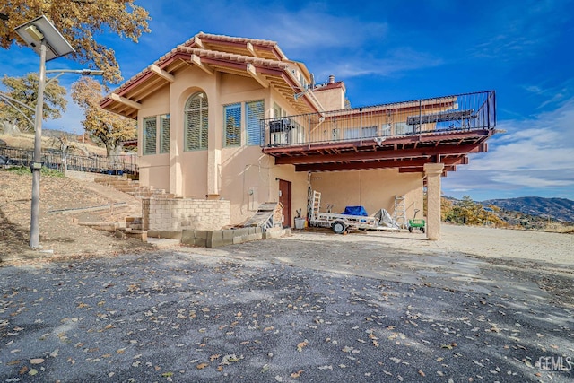 rear view of property featuring a mountain view