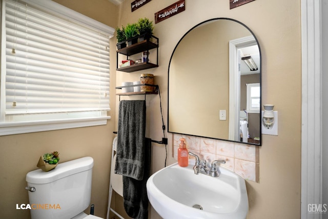 13271 Garzoli Ave, Mc Farland, CA 93250 - bathroom featuring a sink, toilet, and decorative backsplash