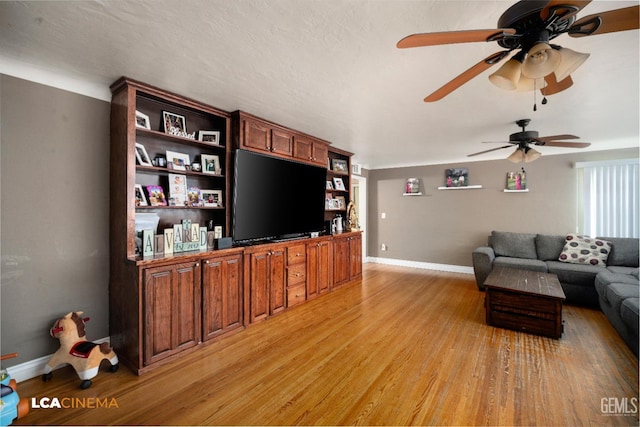 13271 Garzoli Ave, Mc Farland, CA 93250 - living room with light wood-type flooring, a ceiling fan, and baseboards