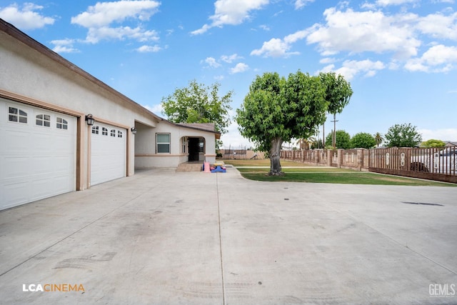 13271 Garzoli Ave, Mc Farland, CA 93250 - garage featuring driveway and fence