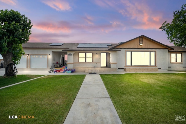 13271 Garzoli Ave, Mc Farland, CA 93250 - ranch-style home with an attached garage, roof mounted solar panels, a front yard, and a shingled roof