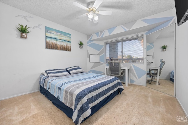 bedroom featuring light carpet, a textured ceiling, ceiling fan, and lofted ceiling