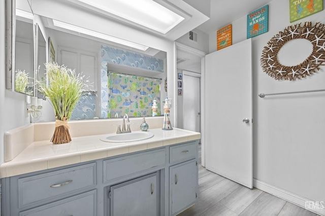 bathroom with hardwood / wood-style floors and vanity