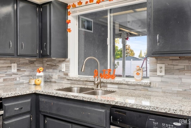 kitchen featuring black dishwasher, light stone counters, sink, and tasteful backsplash