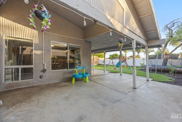 view of patio / terrace with a playground and a trampoline