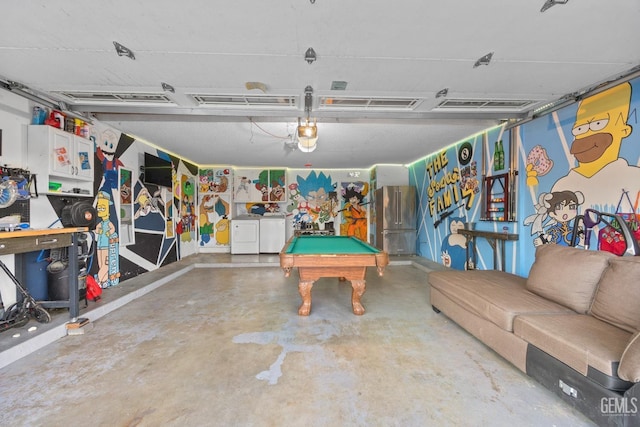 recreation room featuring concrete floors, washer and clothes dryer, and pool table