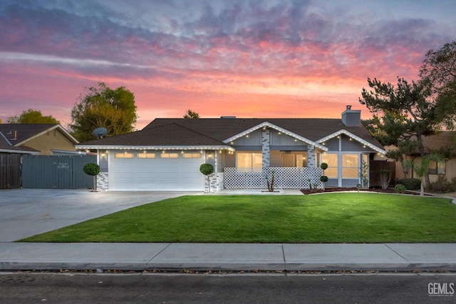 ranch-style home with a lawn and a garage