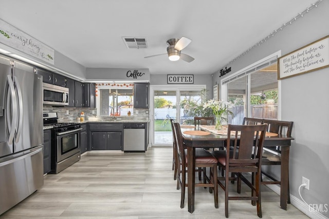 kitchen with tasteful backsplash, ceiling fan, and stainless steel appliances