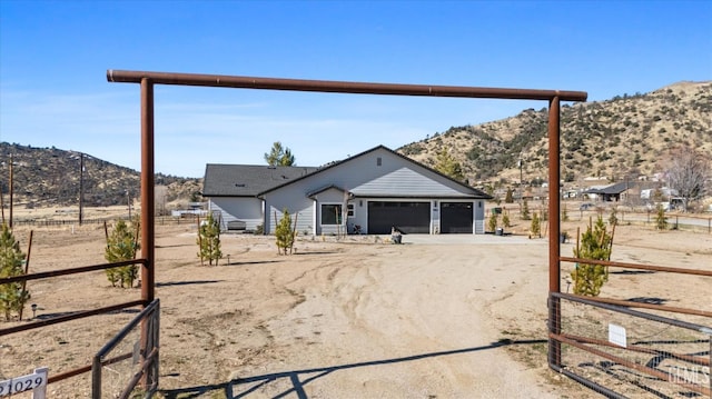 view of front facade with a garage and a mountain view