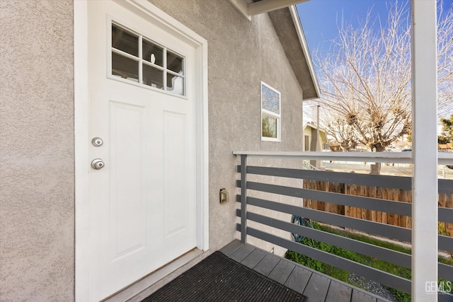 view of exterior entry with stucco siding