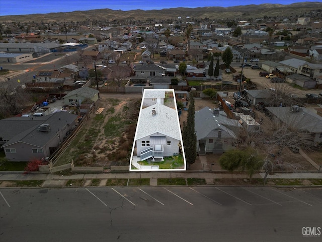 birds eye view of property featuring a mountain view and a residential view