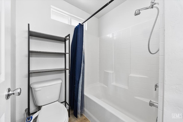 bathroom with toilet, wood finished floors, and shower / bath combo with shower curtain